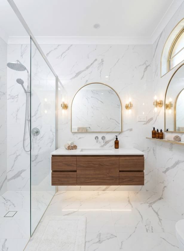 Modern commercial bathroom renovation featuring a floating wooden vanity,